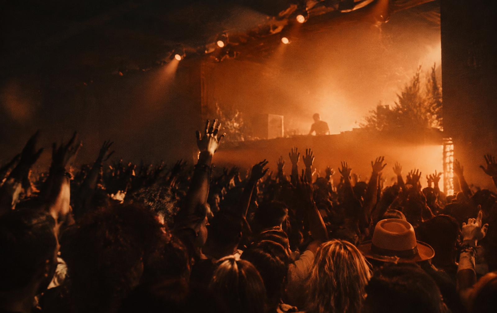 Crowd with raised hands at a WILDWEST night